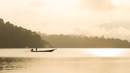 Fisherman on the boat in dam (Ratchaprapa Dam) of Suratthani, Thailandの写真素材