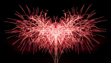 Red fireworks combination on the dark skyの写真素材