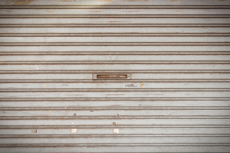 Background of pattern steel slide door with rust and dirtyの写真素材