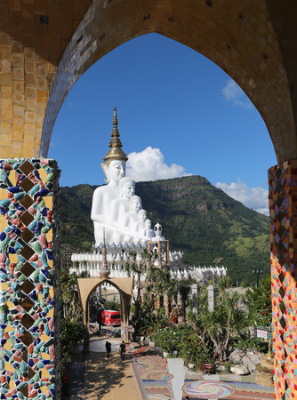 Phetchabun, Thailand - November 23, 2015: Seeing white buddha statue in Wat Phasornkaew or Glass cliff temple through dome decorated by colorful mosaic tiles.のeditorial素材