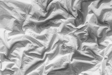 Close up on black and white tone color background of white wrinkled cotton blanketの写真素材