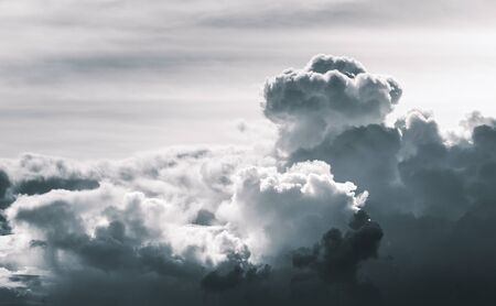 Dark cloud expand from blowing wind on cloudy sky in desaturated color tone.の写真素材