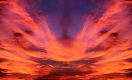 Dramatic sky of saturated orange clouds expanding from wind after sunset which is nature warning...