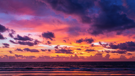 Colorful cloudy sunset sky of twilight at beach of Phuket, Thailand. Dark clouds floating before rain storm coming at night.の写真素材