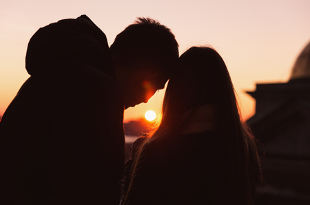 Saint Petersburg, Russia - September 17, 2017: Silhouette scene of unknown couple on roof of Saint Isaacâs cathedral during warm sunset of winter.のeditorial素材