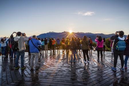 Alishan, Taiwan - November 8, 2017: Tourists in unison photograph sunrise appear over edge of Zhushan mountain at Alishan recreation area of Taiwan.のeditorial素材