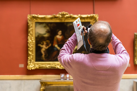 St. Petersburg, Russia - September 20, 2017: Tourist photograph painting artwork on wall inside State Hermitage Museum.のeditorial素材