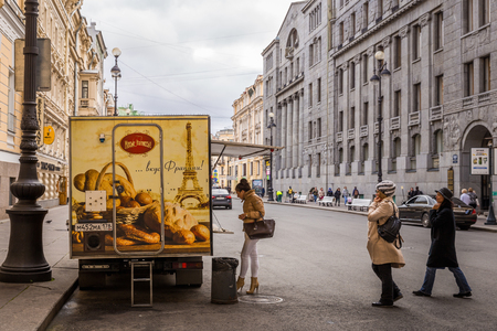 St. Petersburg, Russia - September 20, 2017: Women walk to the car shops selling french bread and croissant on street.のeditorial素材