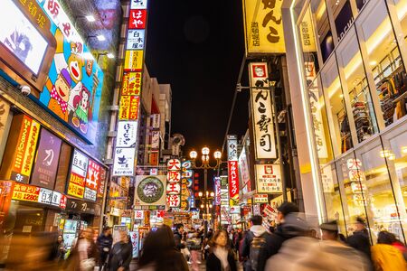 Dotonbori, Osaka, Japan - November 26, 2018: Blurry movement of walking crowd on shopping street.のeditorial素材