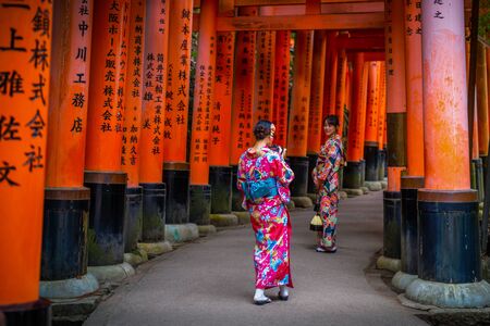 Kyoto, Japan - November 21, 2018: Ladies wear yukata in Fushimi Inari shrine which wrote by japanese language.のeditorial素材