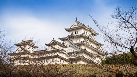 Hyogo, Japan - November 23, 2018: The ancient Himeji castle with blue sky in winter. Most of trees in park starting to fall.のeditorial素材