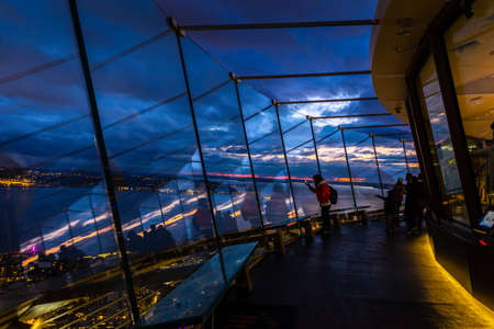 Seattle, Washington, USA - October 9, 2019: Silhouette scene of tourists looking down through big...