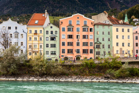 Innsbruck, Austria - November 3, 2019: Colorful buildings on street near Inn river at old city of Innsbruck, Tyrol.のeditorial素材