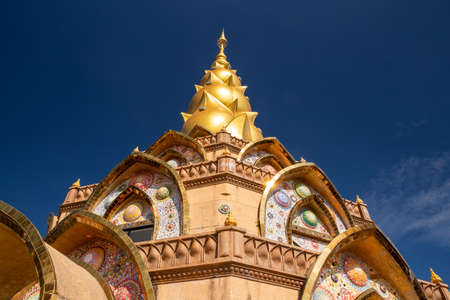 Buddhist tower in pagoda shape with golden peak with blue sky in temple of Thailand.の写真素材