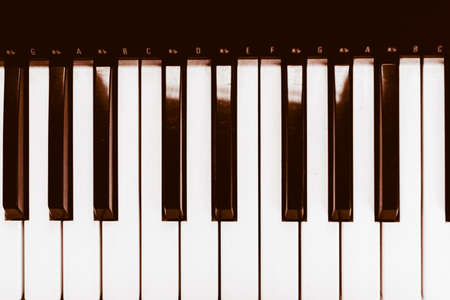 Close focus on piano keyboard with warm tone of black and white.の写真素材