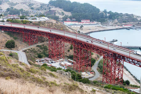 Aerial view over road of Golden Gate bridge connecting to the land near Battery Spencer, California,...