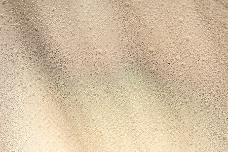 Close focus of water drop from rain on brown synthetic fabric of tent.の写真素材