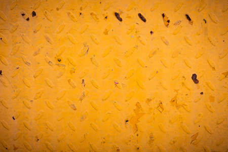 Orange grunge metal background with scratches and rust on steel painted embossing surface of...