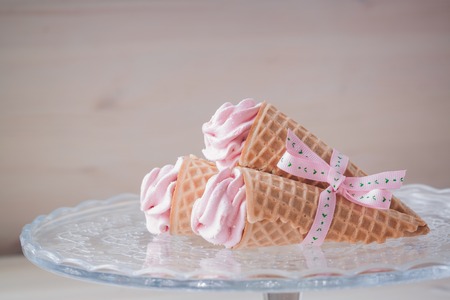 Pink raspberry flavour marshmallows zephyr on the wooden background. Ice-cream like.の写真素材