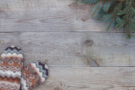 Knitted wool mittens on old wooden background with copy space. Rustic.の写真素材