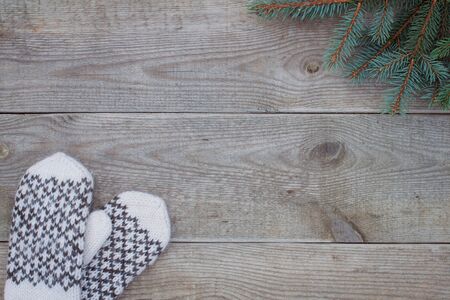 Knitted wool mittens on old wooden background with copy space. Rustic.の写真素材