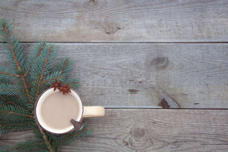 A vintage coffee cup with a branch of Christmas-tree on the old wooden background. With a copy-spaceの写真素材