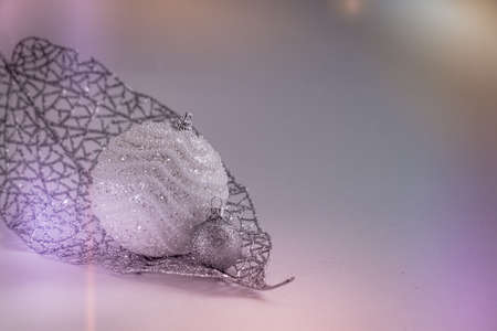 Christmas New Year card with silver balls toys and glittering branch on grey background. Toned.の写真素材