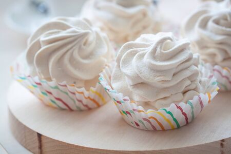 Breakfast wit marshmallow or zephyr with a cup of coffee near Christmas poinsettia. Toned.の写真素材