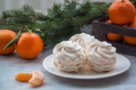 Tangerines flavour marshmallows or zephyr Christmas treat with branches of a fir treeの写真素材
