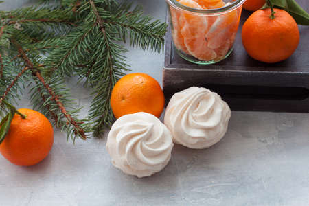Tangerines flavour marshmallows or zephyr Christmas treat with branches of a fir treeの写真素材