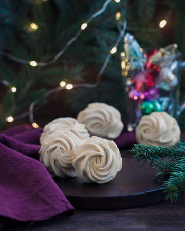 Homemade marshmallows or zephyr on the wooden background with a linen napkinの写真素材