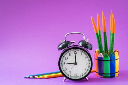 Alarm set at 9 o'clock, colorful cactus, rainbow pencils, working school drawing concept, ultraviolet backgroundの写真素材