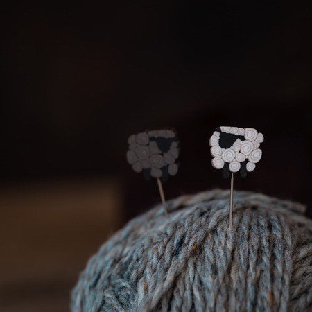 White and black sheep on the yarn balls, knitting postcard concept, tonedの写真素材