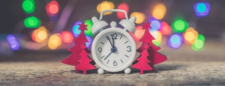 Christmas vintage red wooden firtrees with garland lights background, holiday bannerの写真素材