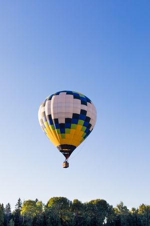 Colorful hot-air balloons flying over the forest, postcard conceptの写真素材