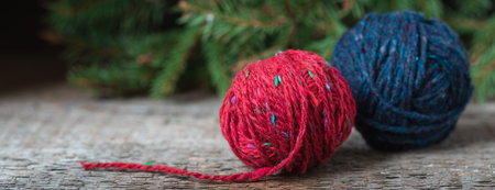 Bright red wool yarn with wooden needles, knitting postcard, tonedの写真素材