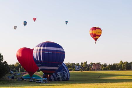 25.08.2018 - Dmitrov, Moscow Region, Russia. Preparation for colorful hot-air balloons flight over the forest, tonedのeditorial素材