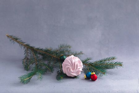 Homemade pink sweet marshmallow on Christmas fir-tree branches, postcard, invitation conceptの写真素材