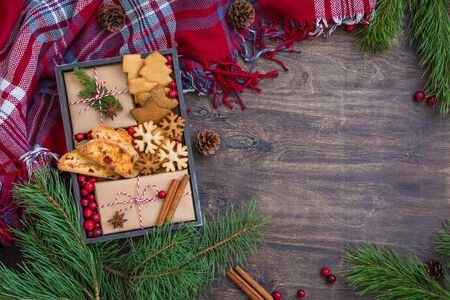 Homemade cookies and biscuits, wrapped presents, fresh cranberries in a wooden box, zero waste christmas conceptの写真素材