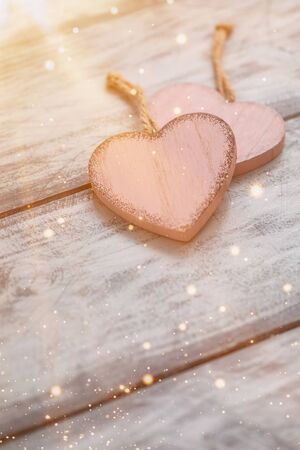 Two pink rustic Valentine's hearts on wooden background, February 14, wedding, proposal, invitation conceptの写真素材