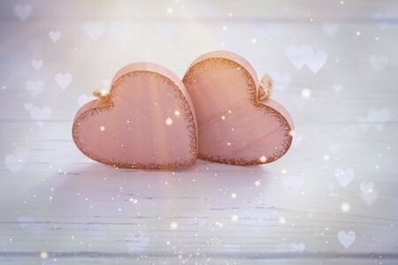 Two pink rustic Valentine's hearts on wooden background, February 14, wedding, proposal, invitation conceptの写真素材