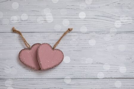 Two pink rustic Valentine's hearts on wooden background, February 14, wedding, proposal, invitation concept, bannerの写真素材