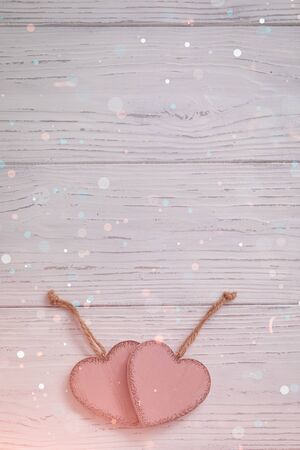 Two pink rustic Valentine's hearts on wooden background, February 14, wedding, proposal, invitation conceptの写真素材