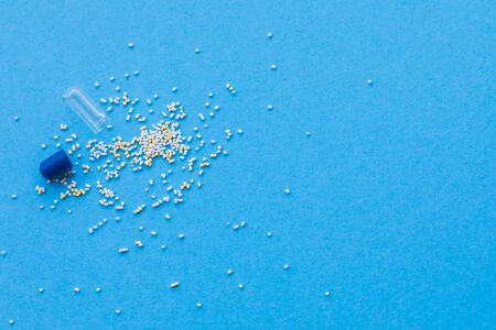 Tablet on blue background, medicine drugs concept, copy spaceの写真素材