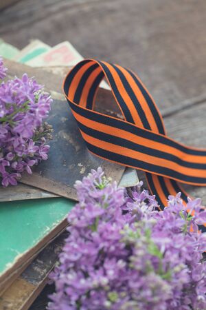St. George ribbon on natural moss wooden background, symbol of Victory Day May 9, tonedの写真素材