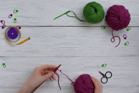 Background with knitting tools and accesories, colorful skein yarn, hobby concept, copyspace, top viewの写真素材