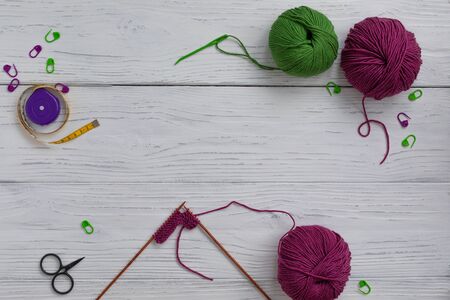 Background with knitting tools and accesories, colorful skein yarn, hobby concept, copyspace, top viewの写真素材