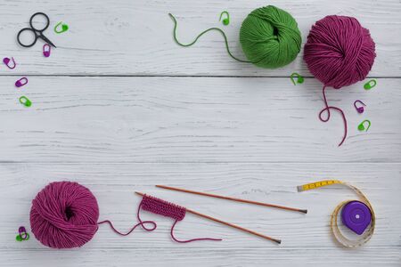 Background with knitting tools and accesories, colorful skein yarn, hobby concept, copyspace, top viewの写真素材