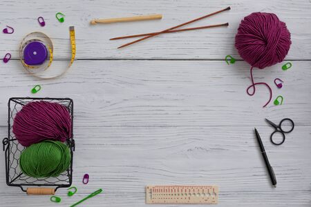 Background with knitting tools and accesories, colorful skein yarn, hobby concept, copyspace, top viewの写真素材