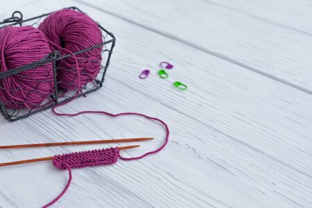 Background with knitting tools and accesories, colorful purple skein yarn, hobby concept, copyspaceの写真素材